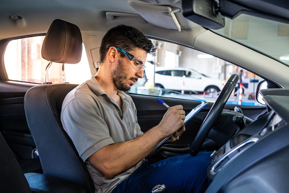 Technician inspecting car interior